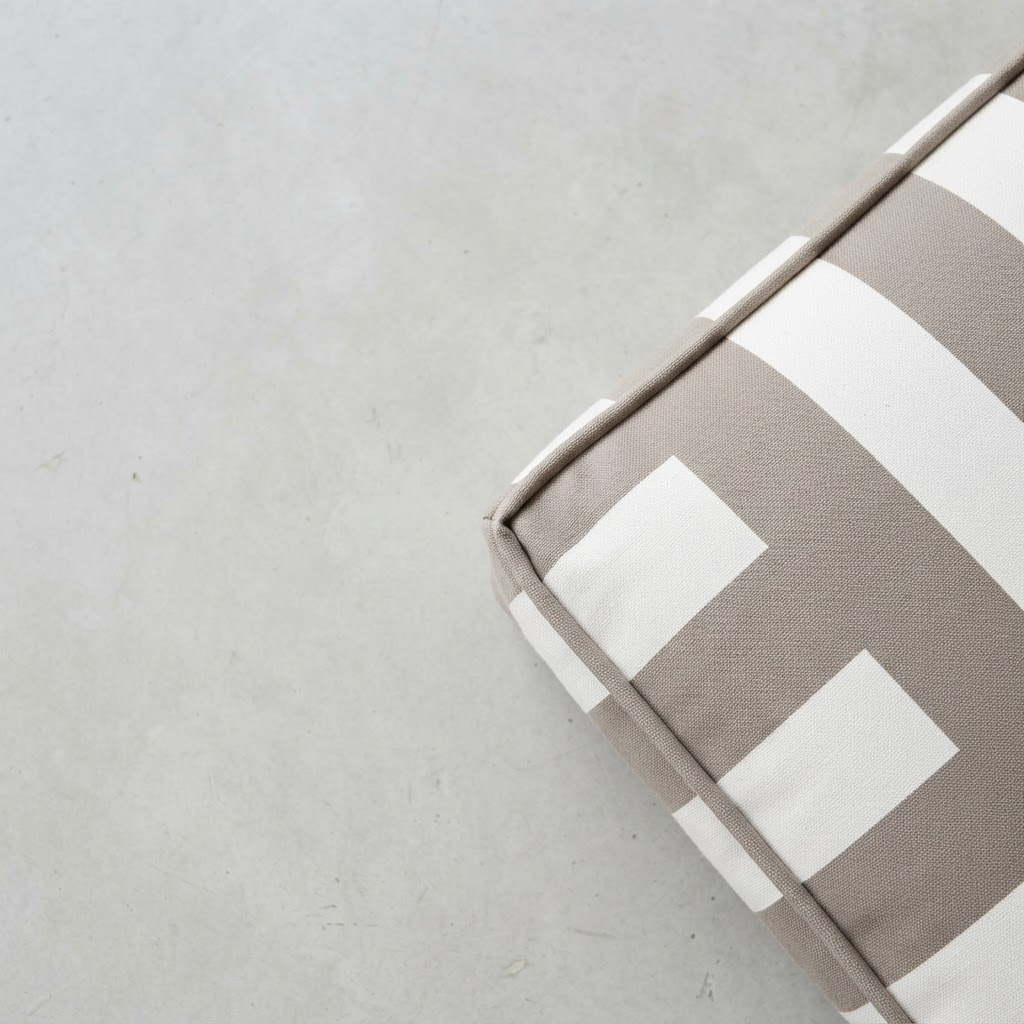 Detail of the piped edge and striped canvas cover of the outdoor cushion